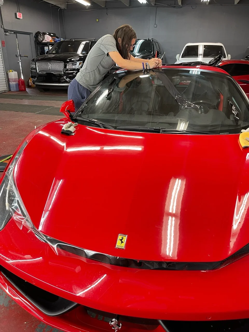 Ferrari 488 receiving windshield paint protection film installation at Allure Auto Spa in Casselberry, Florida
