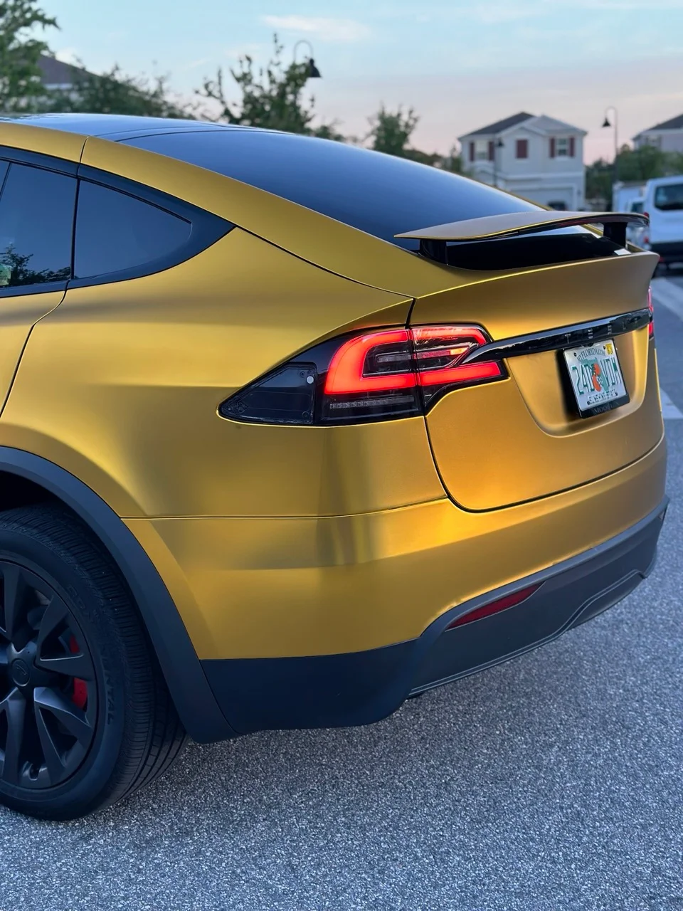 Rear view of a satin gold wrapped Tesla Model X done at Allure Auto Spa in Casselberry, Florida