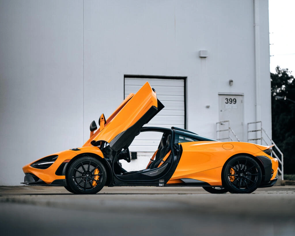 Orange McLaren 720S detailed with butterfly doors open at Allure Auto Spa in Casselberry, Florida