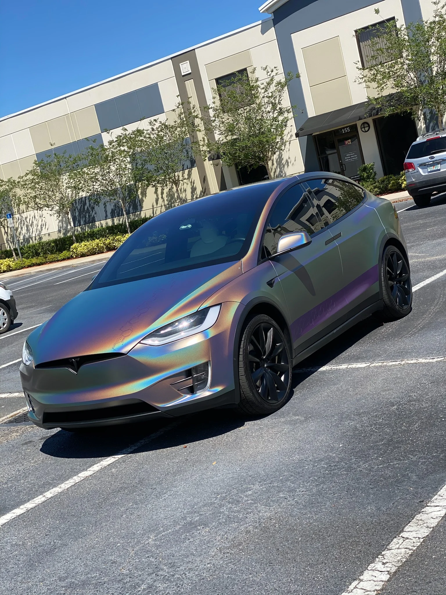 Tesla Model X with an iridescent wrap and high-contrast dark tint installed by Allure Auto Spa in Casselberry, Florida