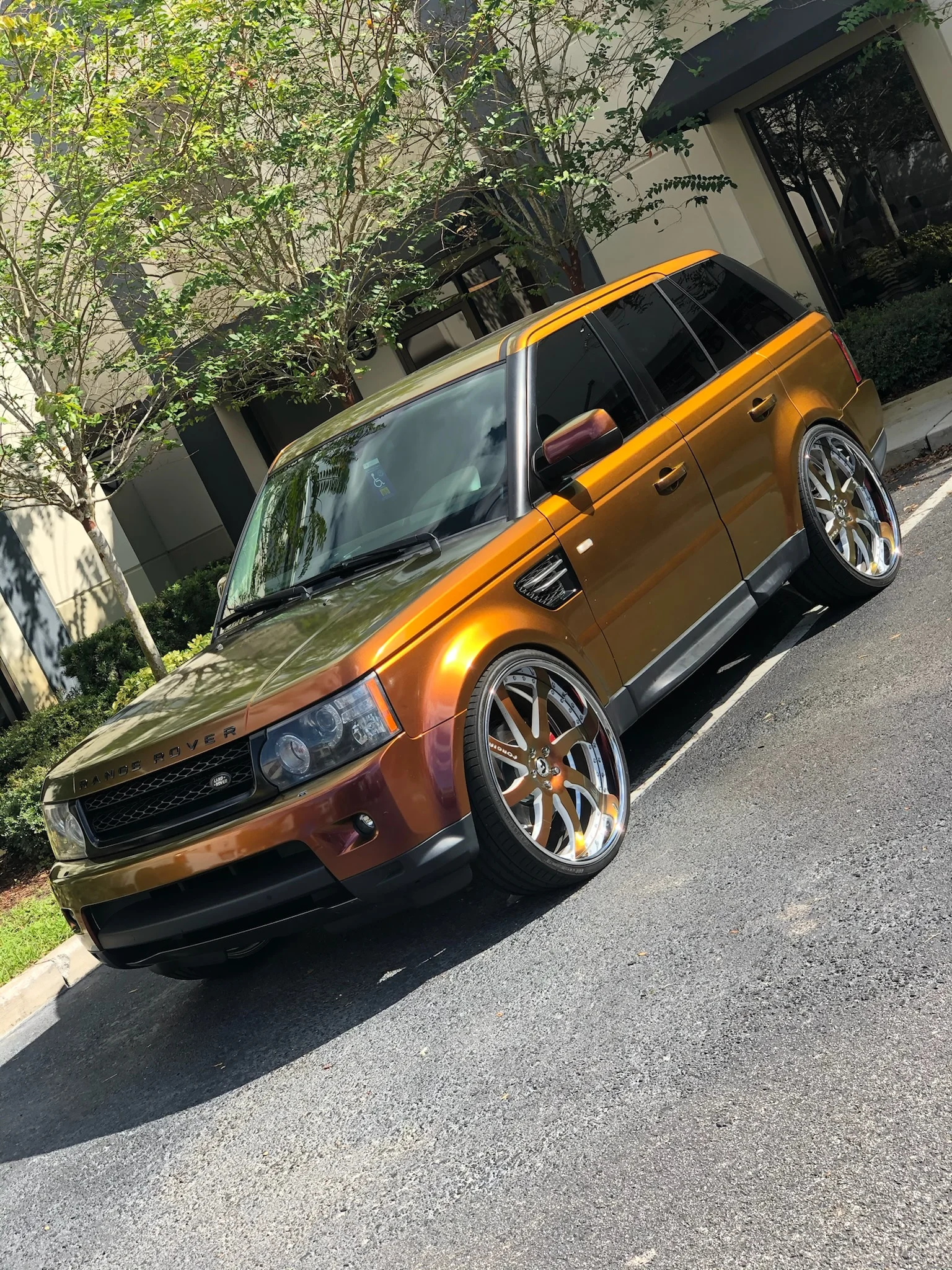 Range Rover with a copper-green chameleon wrap and dark window tint at Allure Auto Spa in Casselberry, Florida