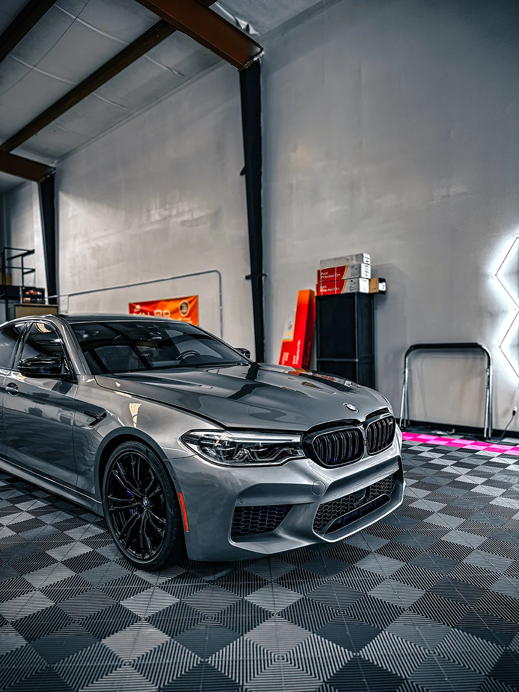 Silver BMW M5 fully wrapped with a sleek finish at Allure Auto Spa in Casselberry, Florida