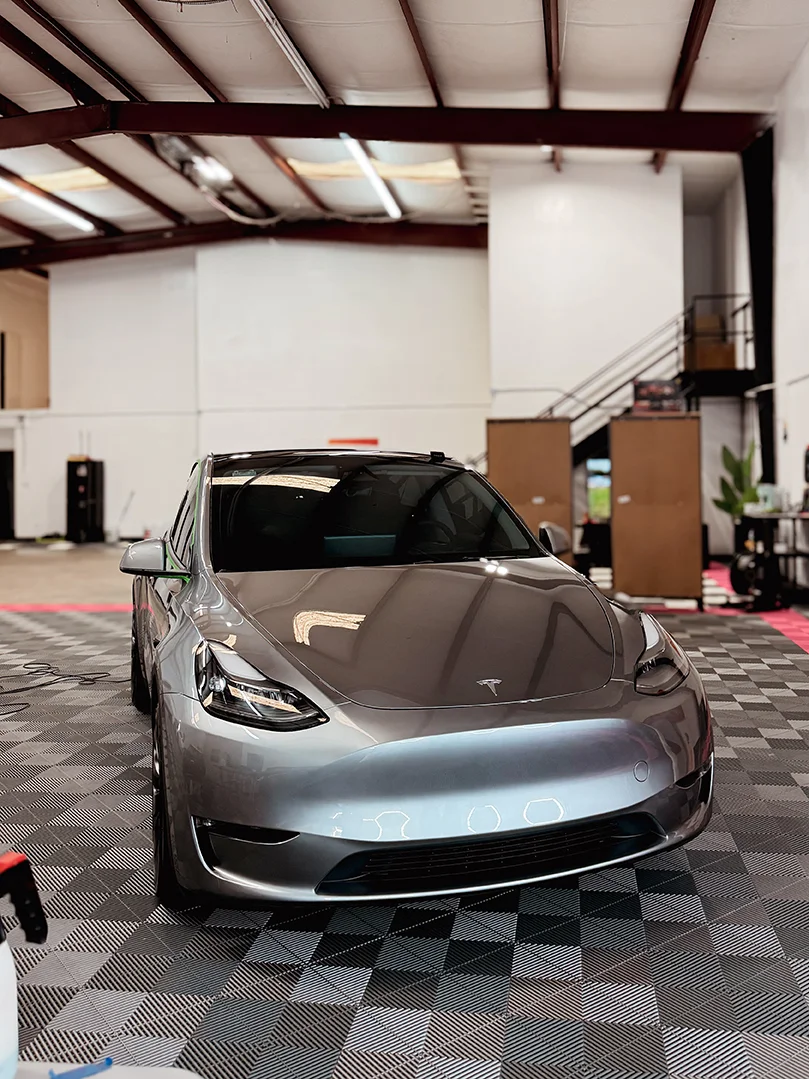 Tesla Model Y with a fresh gloss wrap finish inside the Allure Auto Spa studio in Casselberry, Florida