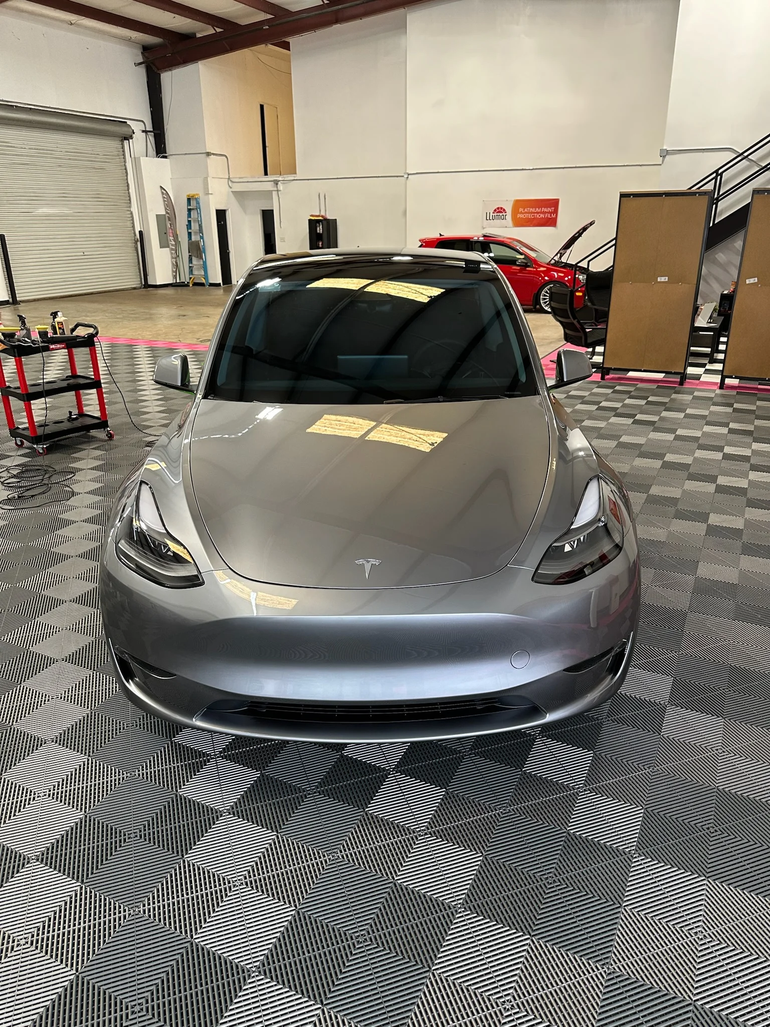 Silver Tesla Model 3 after receiving front paint protection film at Allure Auto Spa in Casselberry, Florida