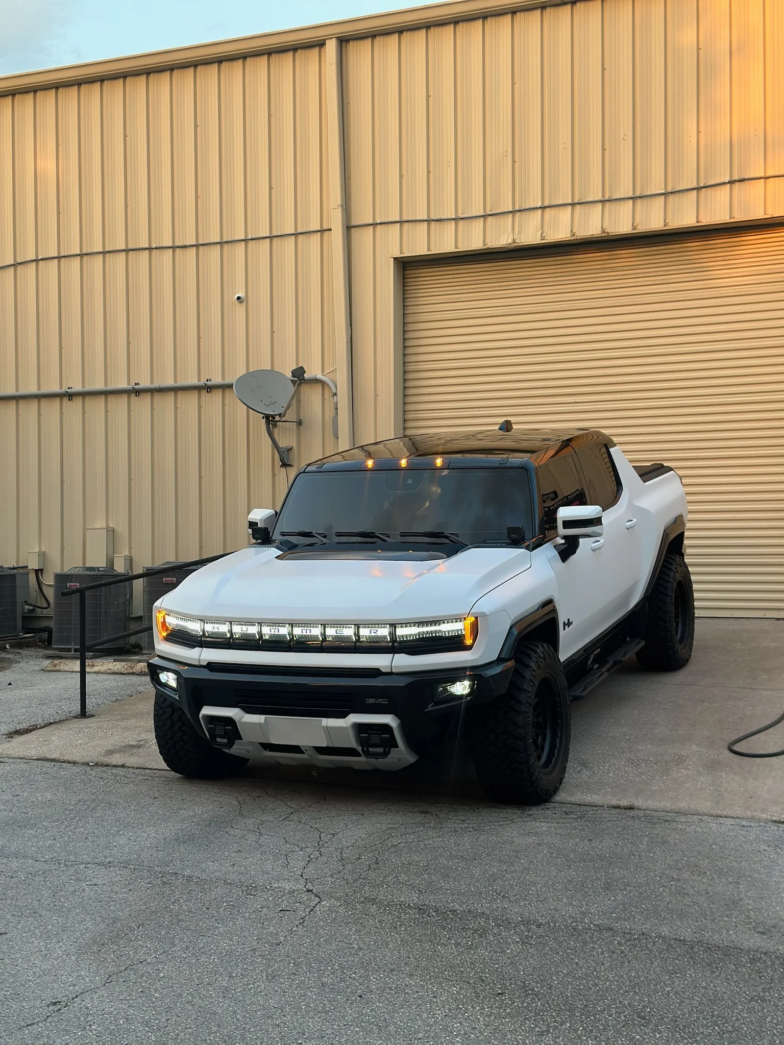 White GMC Hummer EV after receiving paint protection film, parked outside Allure Auto Spa in Casselberry, Florida