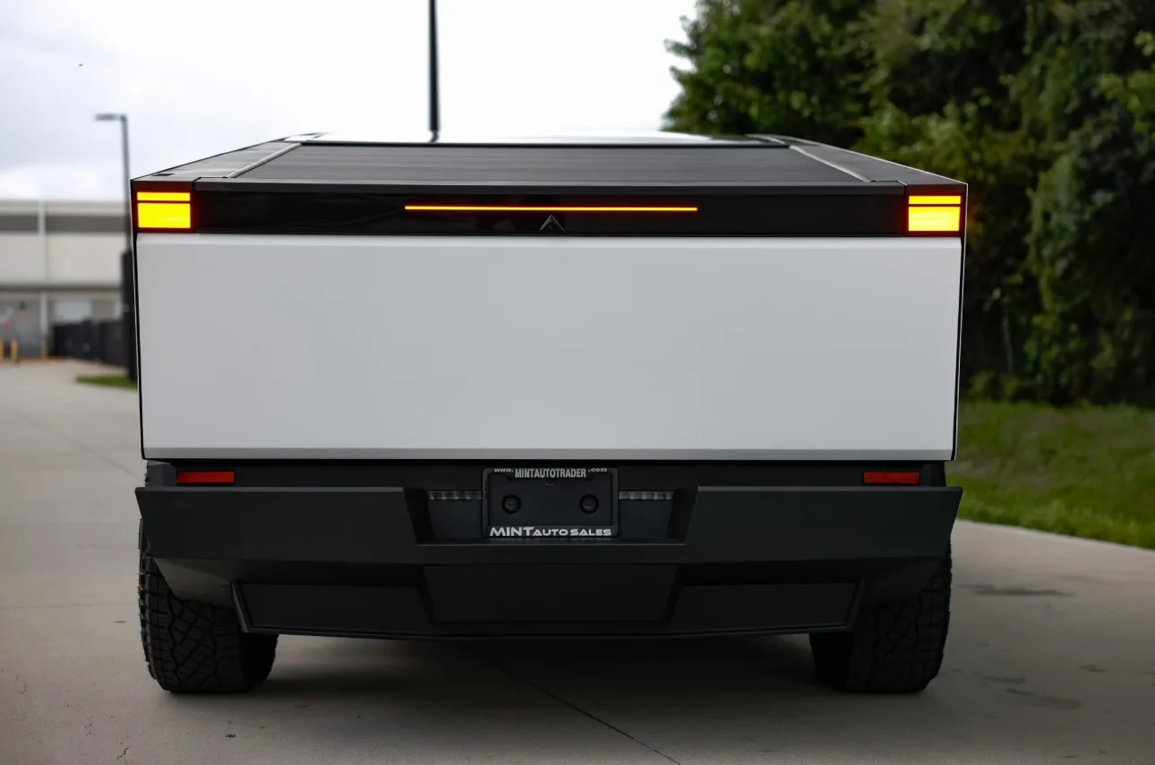 Rear view of a custom-wrapped Tesla Cybertruck with a roll-up bed cover, demonstrating a complete vehicle transformation by Allure Auto Spa