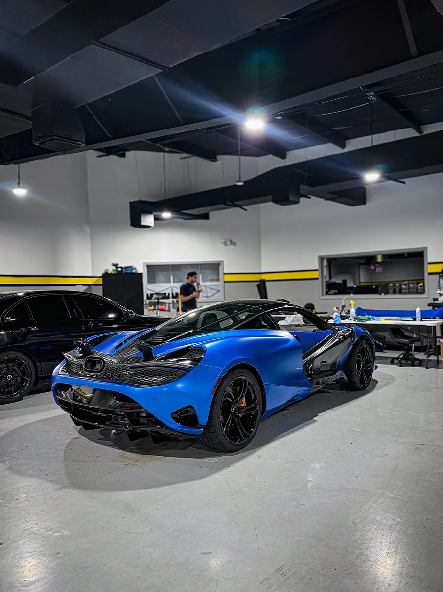 Stunning satin blue car wrap applied to a McLaren 720S, showcasing premium vehicle customization by Allure Auto Spa