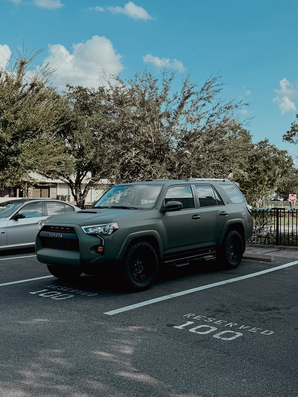 Rugged Toyota 4Runner SUV wrapped in a custom matte green film, showcasing durable vehicle wraps from Allure Auto Spa