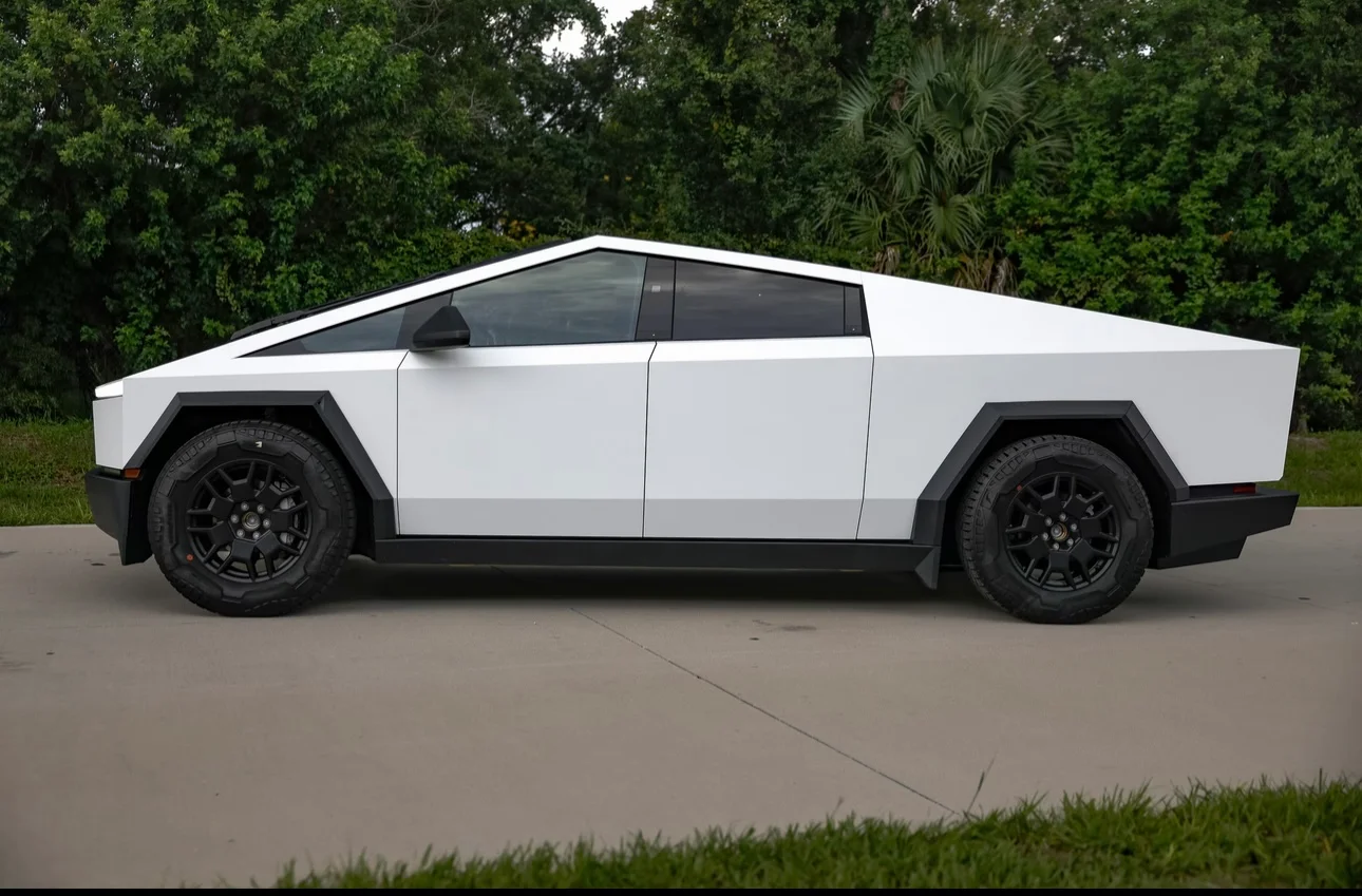 Full side view of a Tesla Cybertruck featuring a clean satin white car wrap, demonstrating custom vehicle finishes by Allure Auto Spa