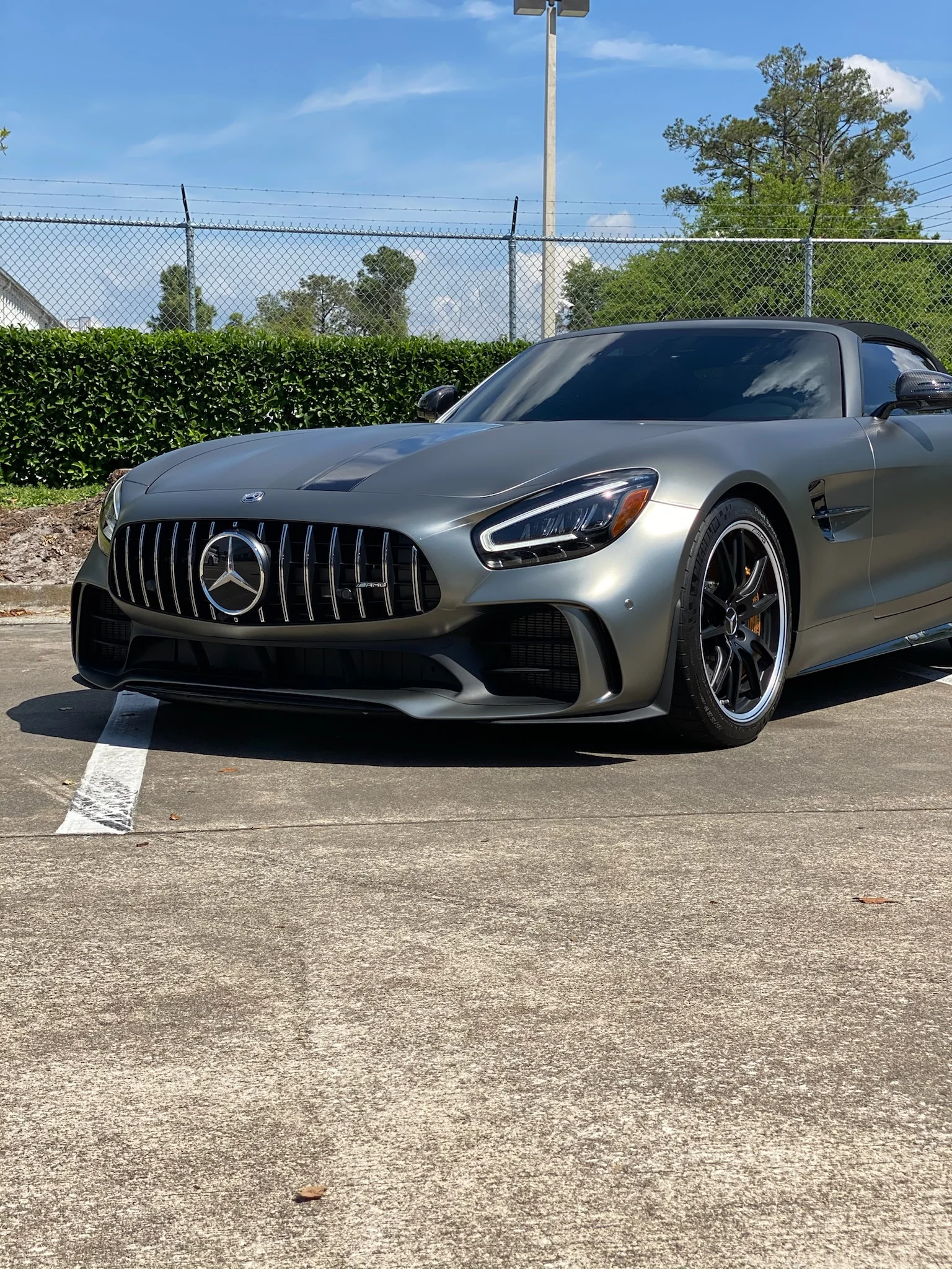 Front angle of a Mercedes-AMG GT Roadster with a sleek matte grey car wrap by Allure Auto Spa