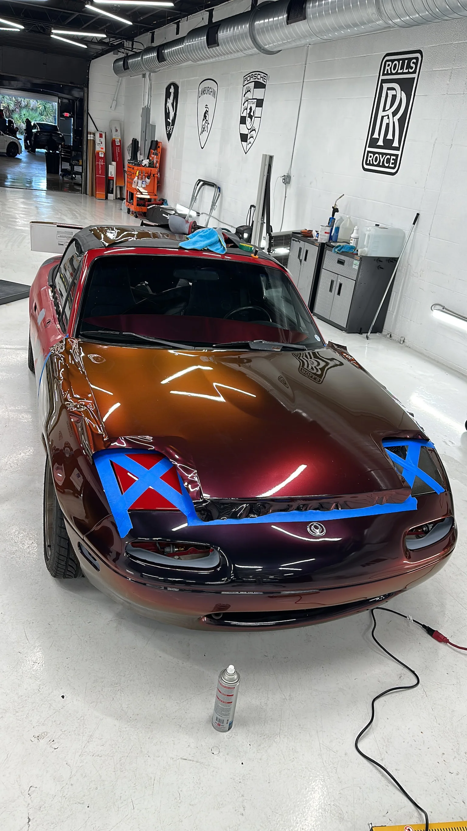 Mazda MX-5 Miata (NA) getting a unique color-shift car wrap, showing the installation process at Allure Auto Spa