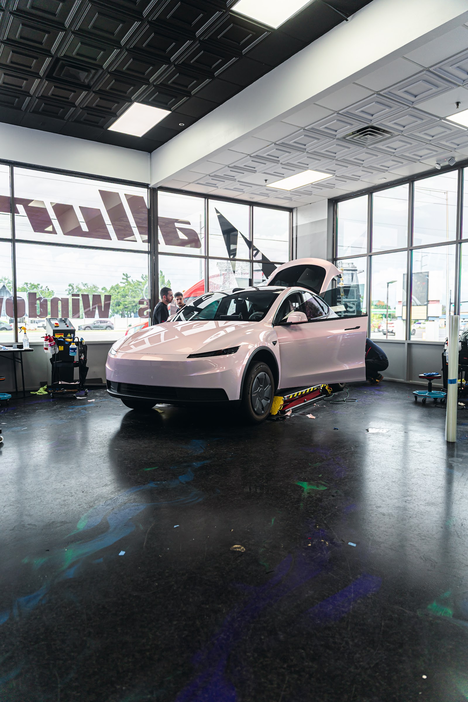 Tesla Model Y getting colored PPF installed at Allure Auto Spa in Fern Park