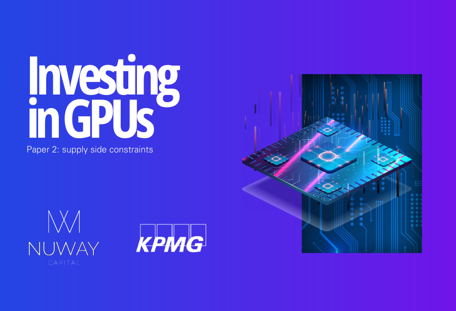  A modern GPU with a dual-fan design, featuring a sleek silver and black color scheme, lies on a wooden surface.