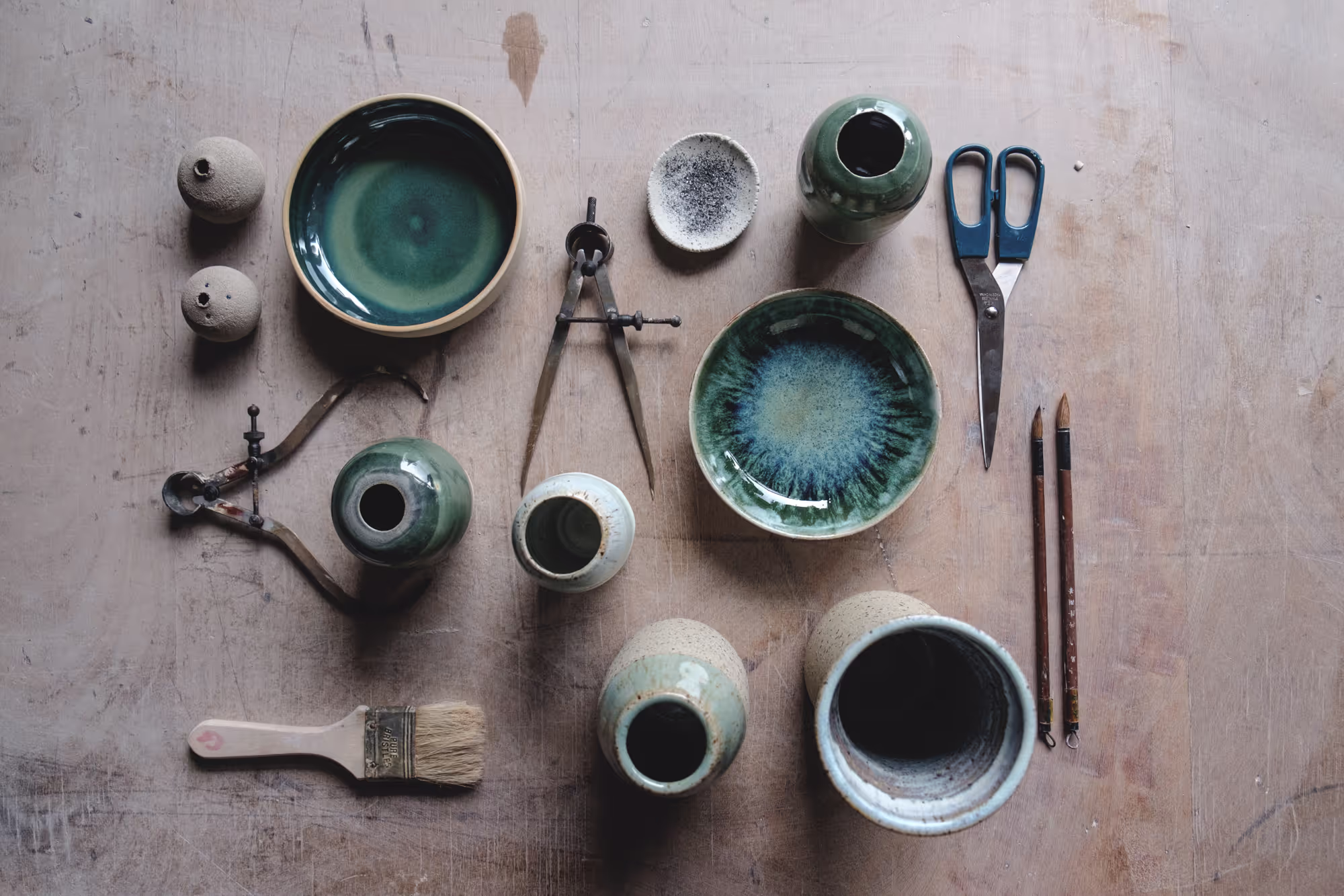 The pottery studio at Turning Earth Leyton in East London, with wooden worktables and hanging plants