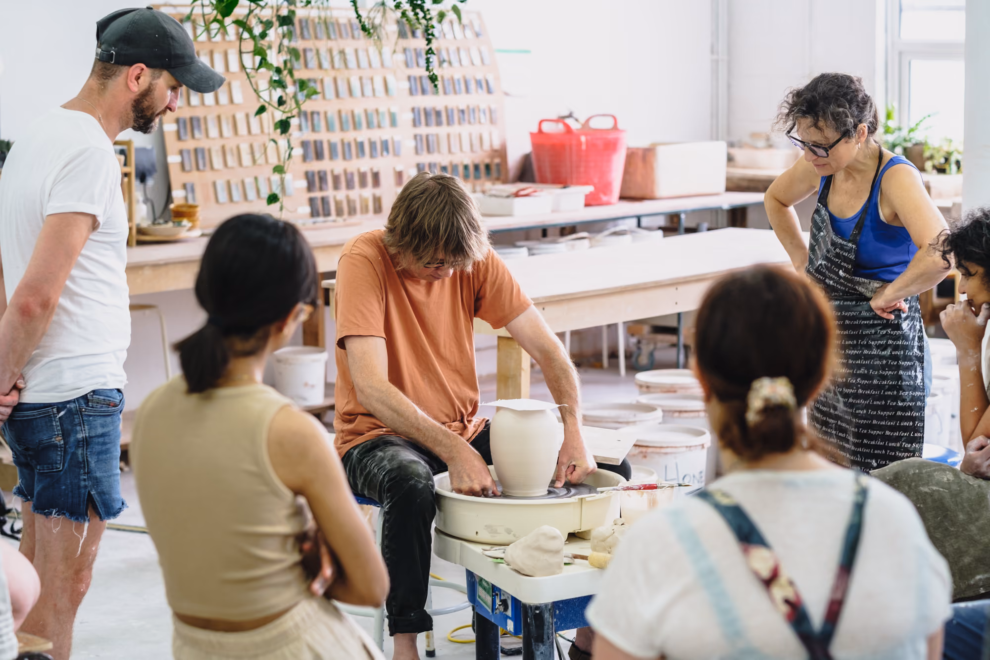 Person shaping clay on a pottery wheel