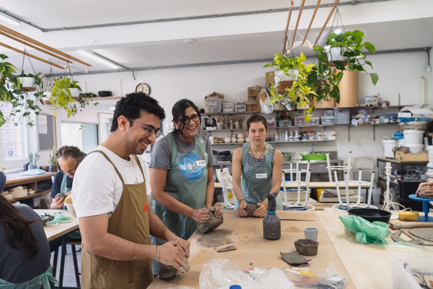 Group working on pottery in a well-lit studio