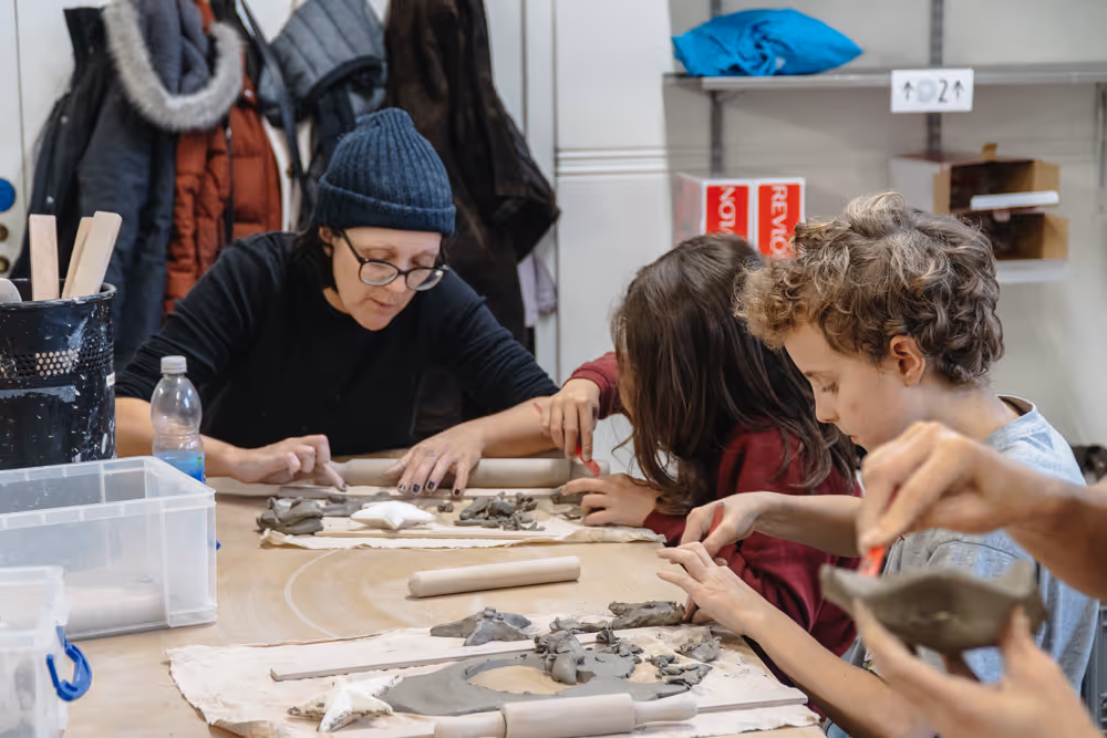 Young people working with clay in a pottery class