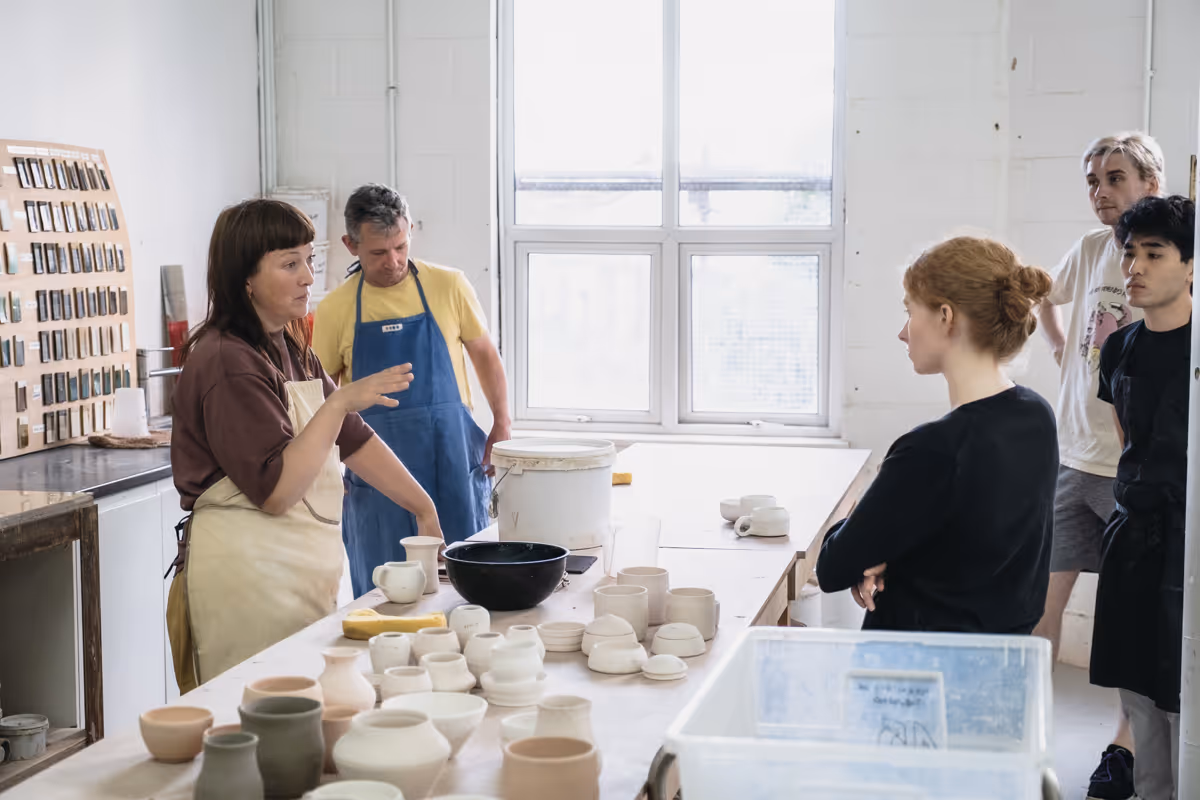 Group working on pottery in a well-lit studio
