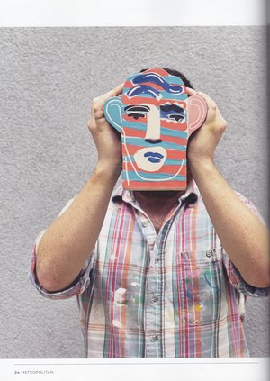 Metropolitan magazine page: a man holds a brightly painted ceramic face in front of his own face