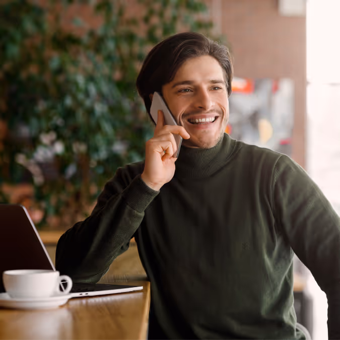 Image of a young business owner on the phone in a coffee shop
