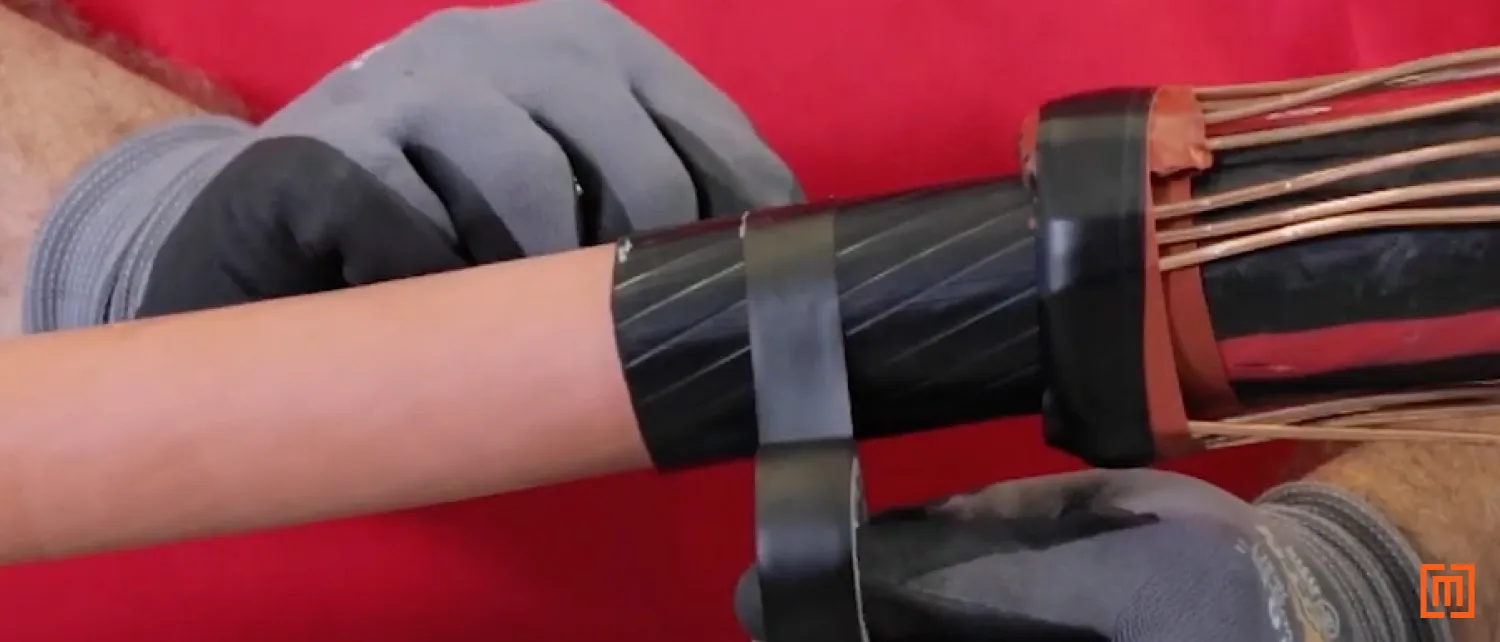 Technician wraps electrical tape around part of the cable