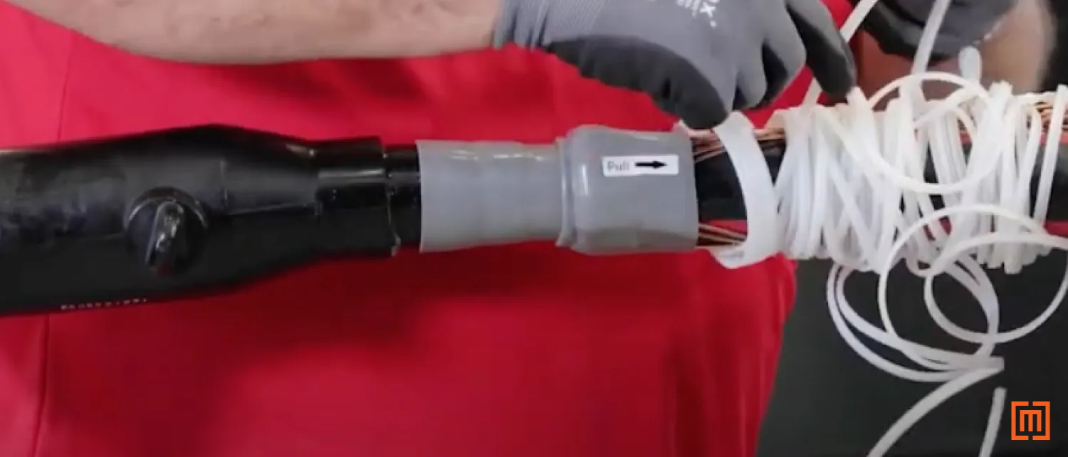 Technician applying cable jacket seal