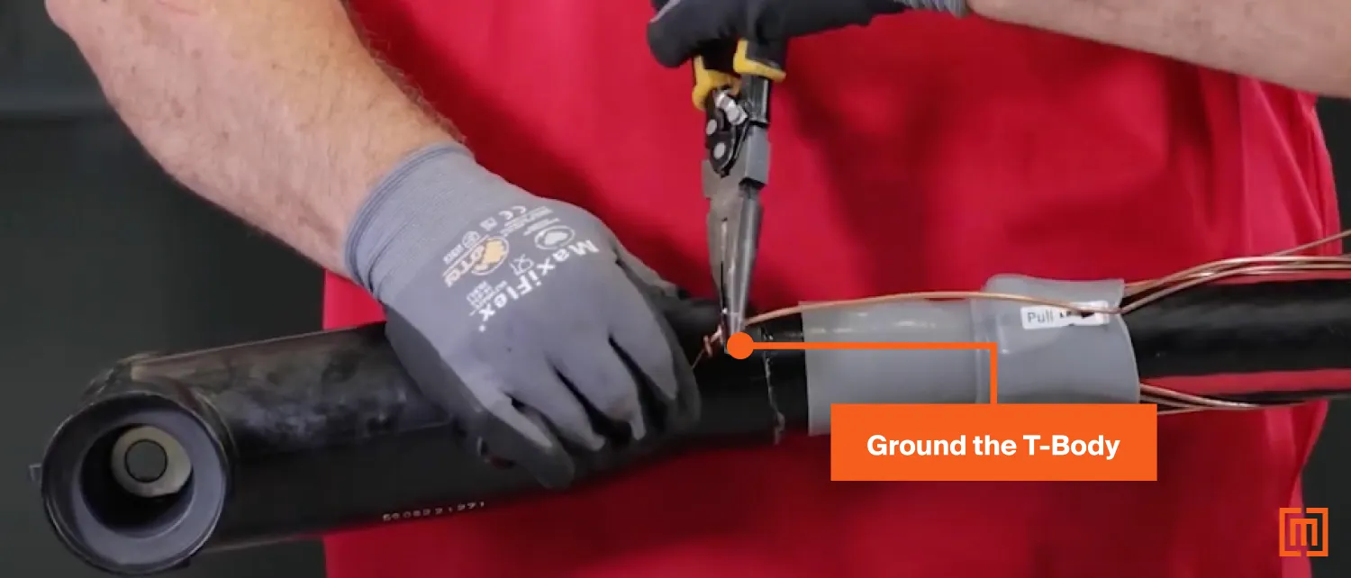 Technician pinching ground wire to T-Body terminal