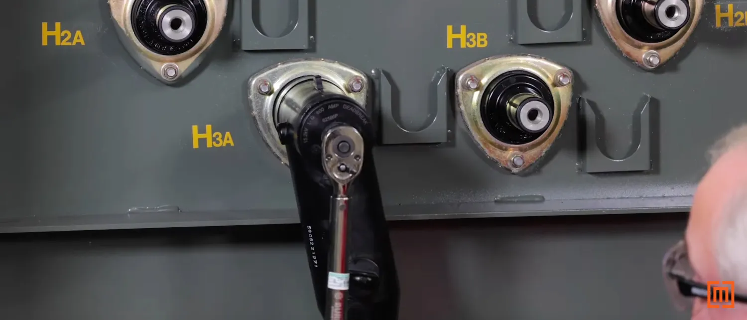Technician wrenching cap to the T-Body head