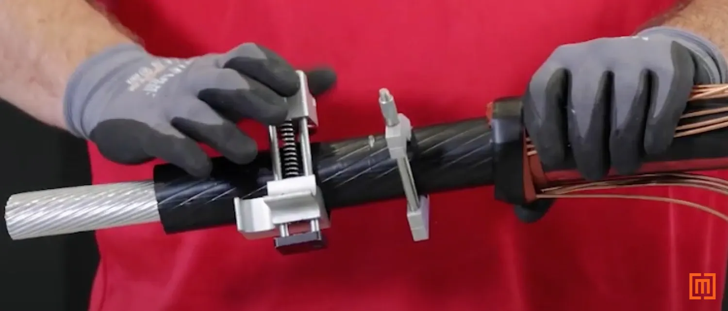 Technician scores the cable and reveals the insulation