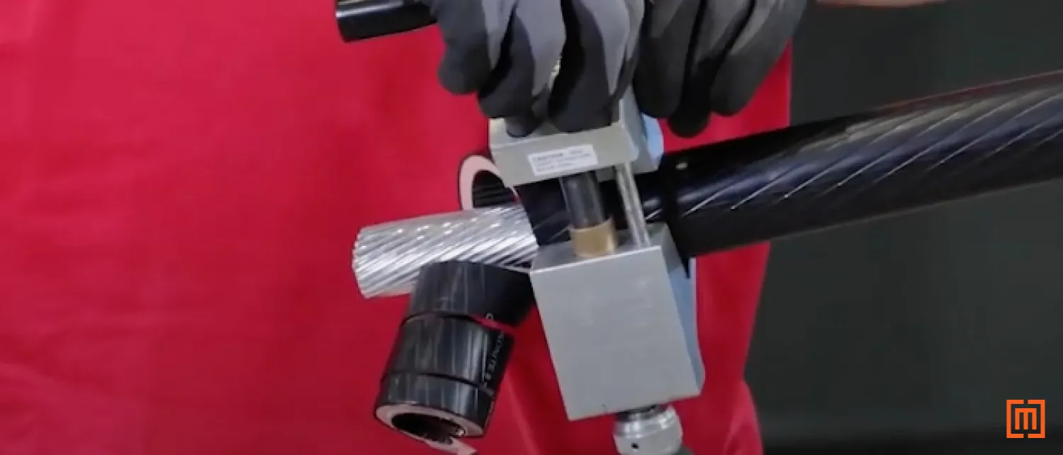 Technician strips the cable of its insulation 3 3/4 inches from the end