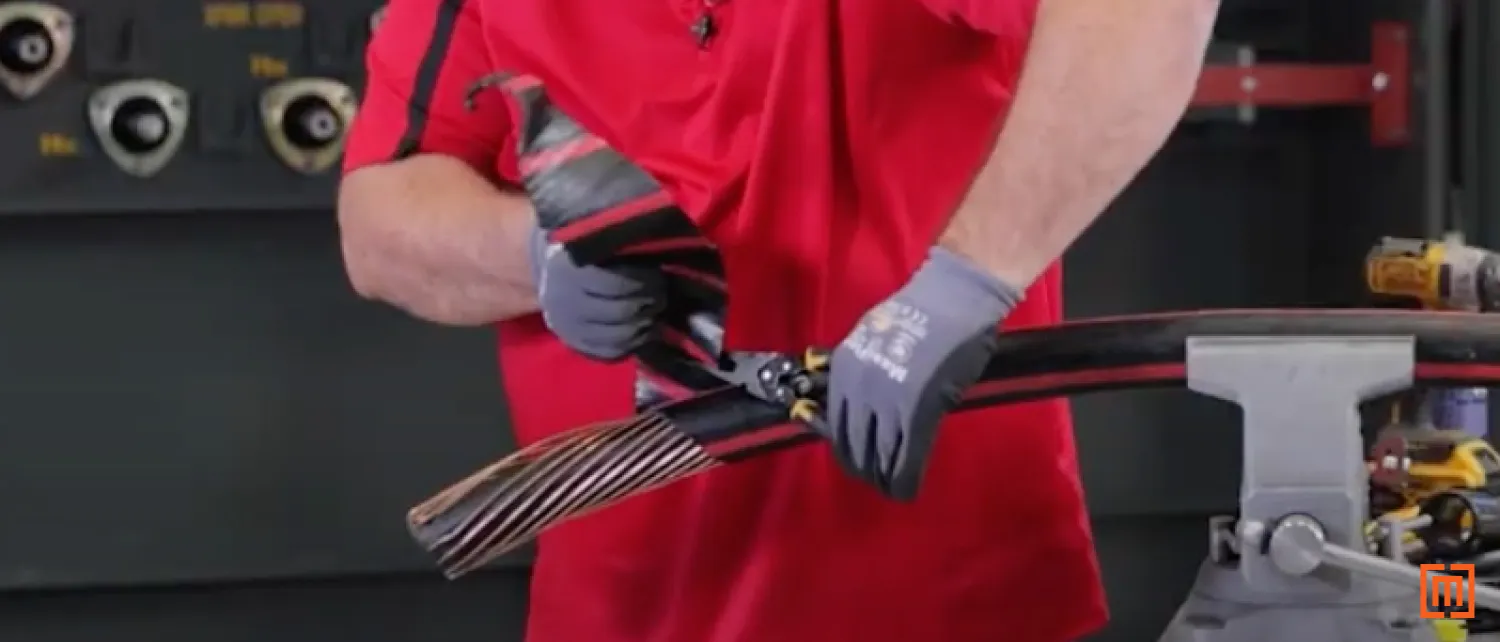 Technician folds back scored cabled jacket