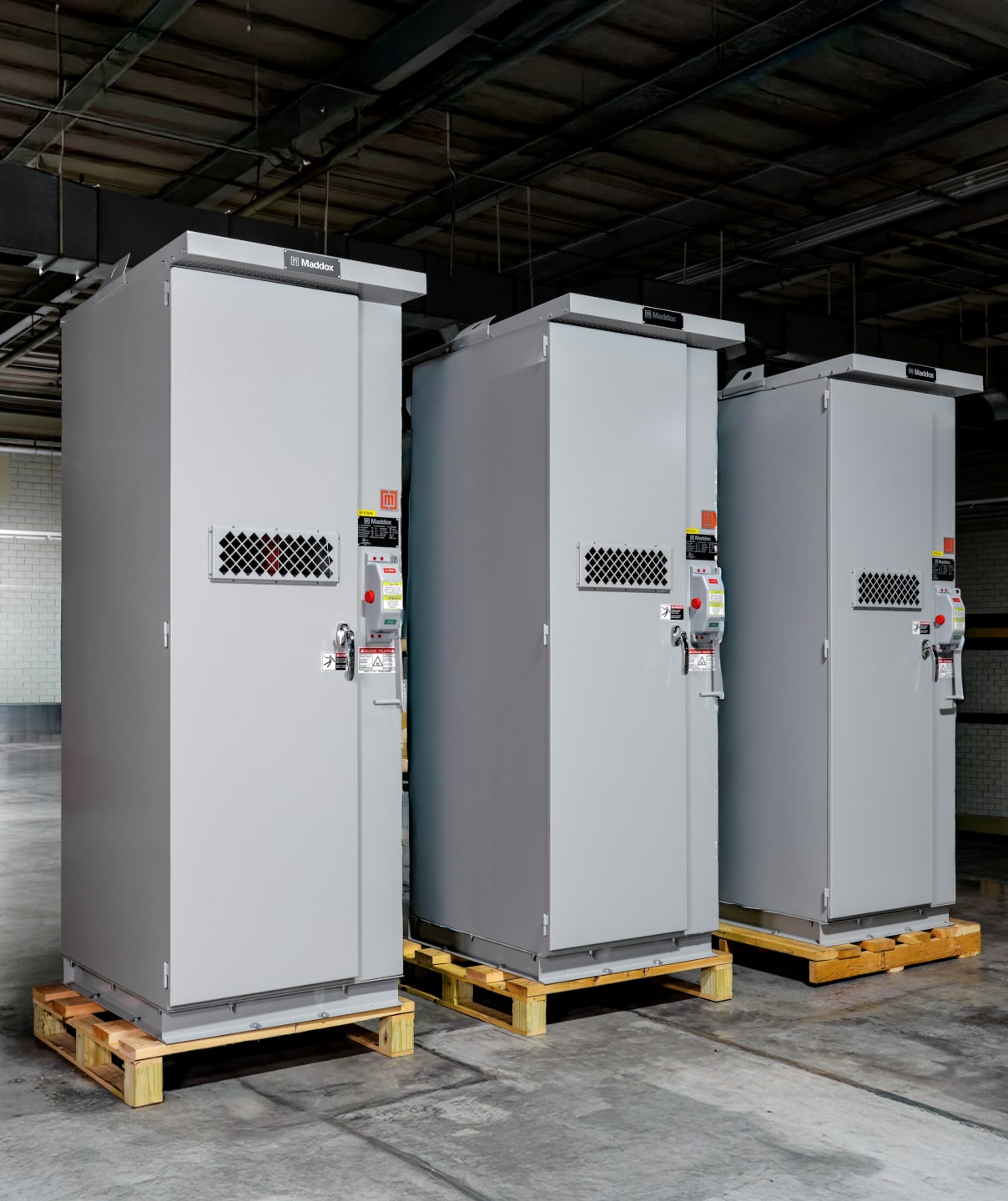 Three Maddox metal-enclosed switchgear in row waiting to ship out.