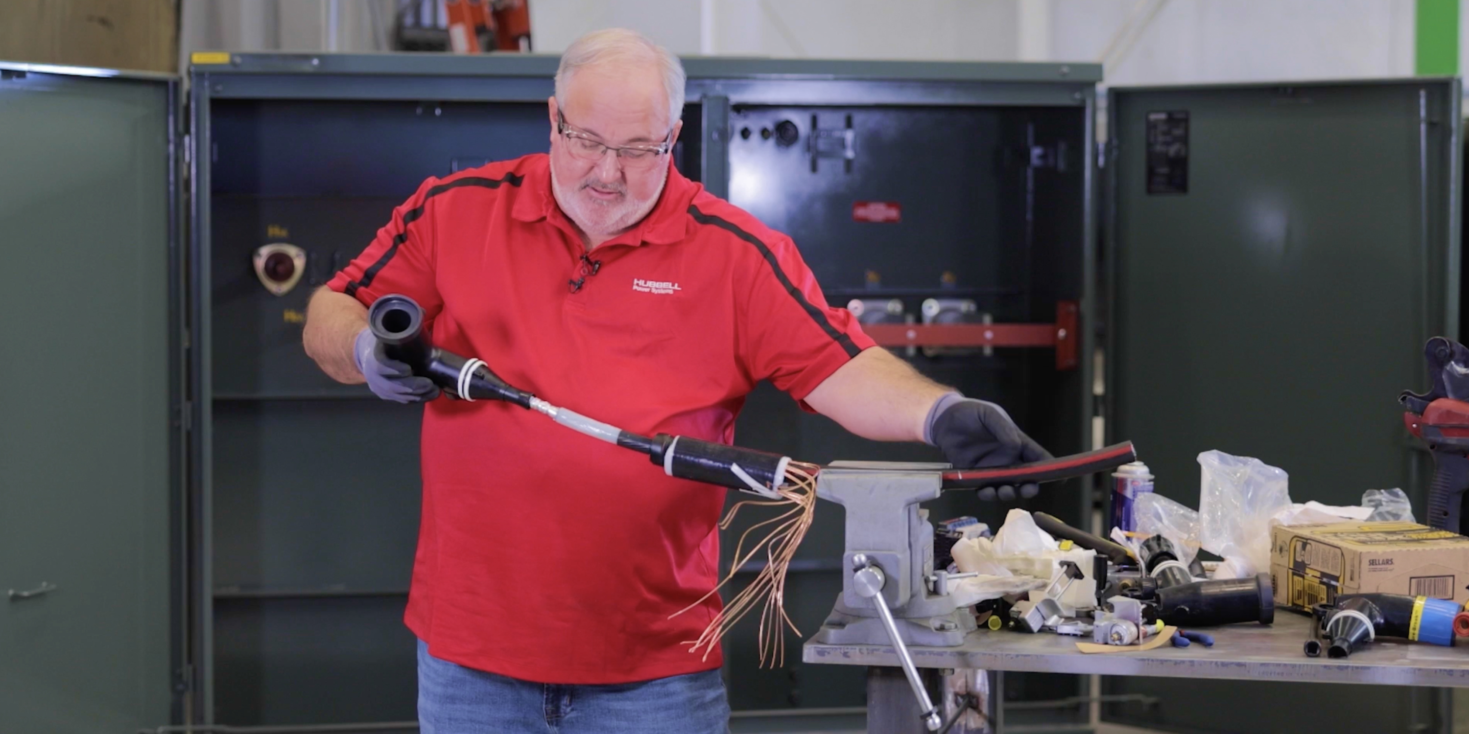 Technician installing loadbreak elbow on to a cable 