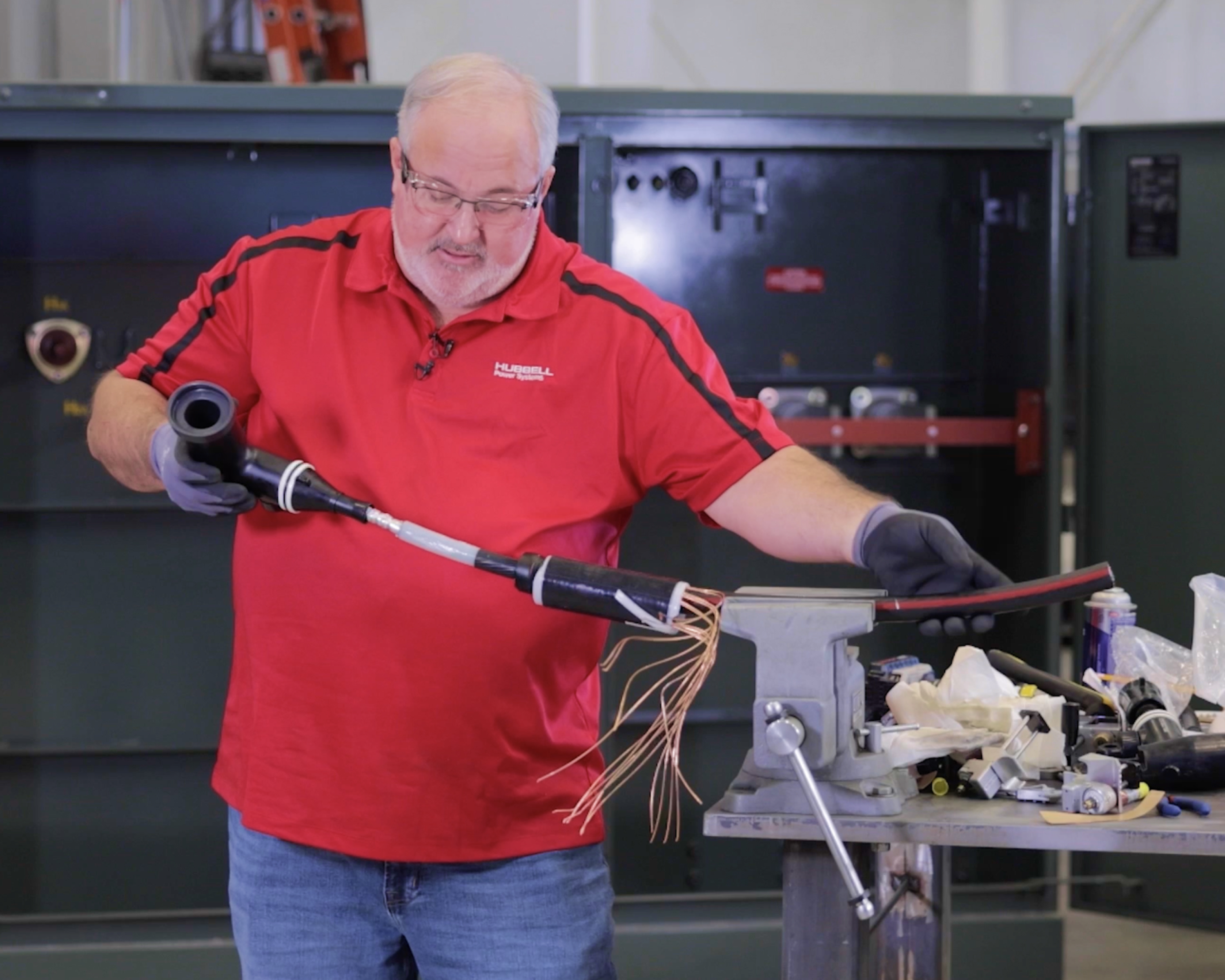 Technician installing loadbreak elbow on to a cable 