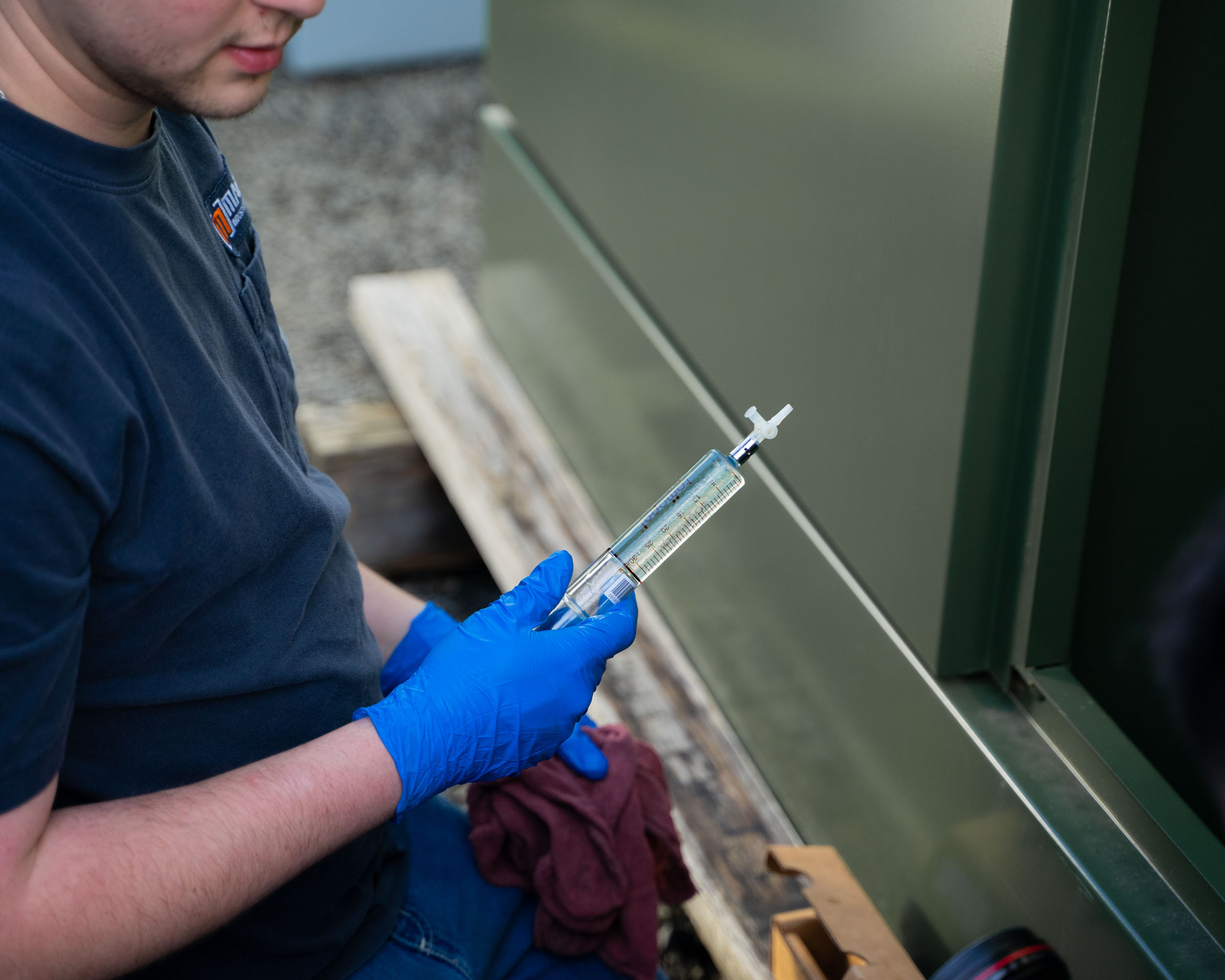 Taking an oil sample from a liquid-filled transformer