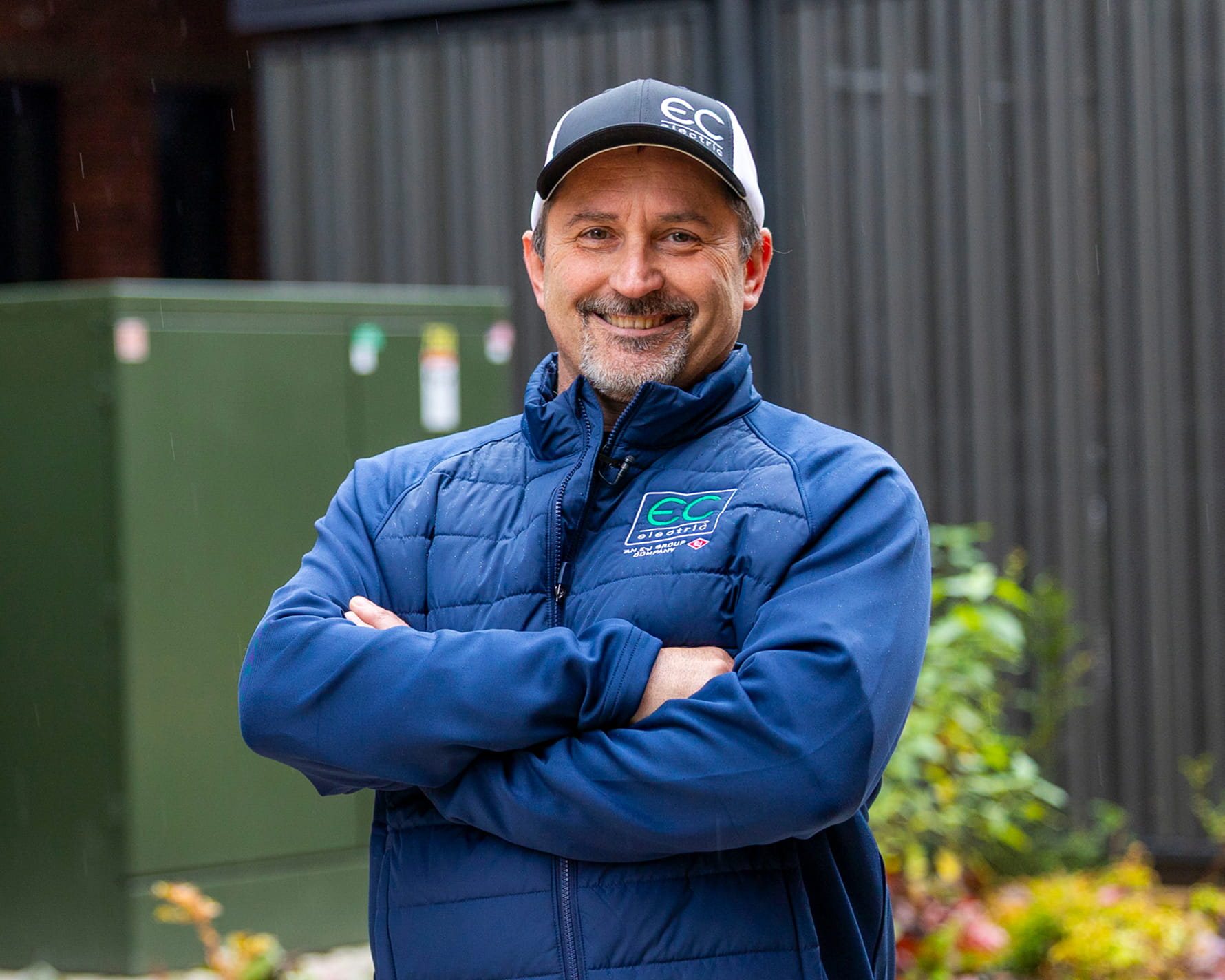 EC Electric contractor standing in front of three padmount transformers 