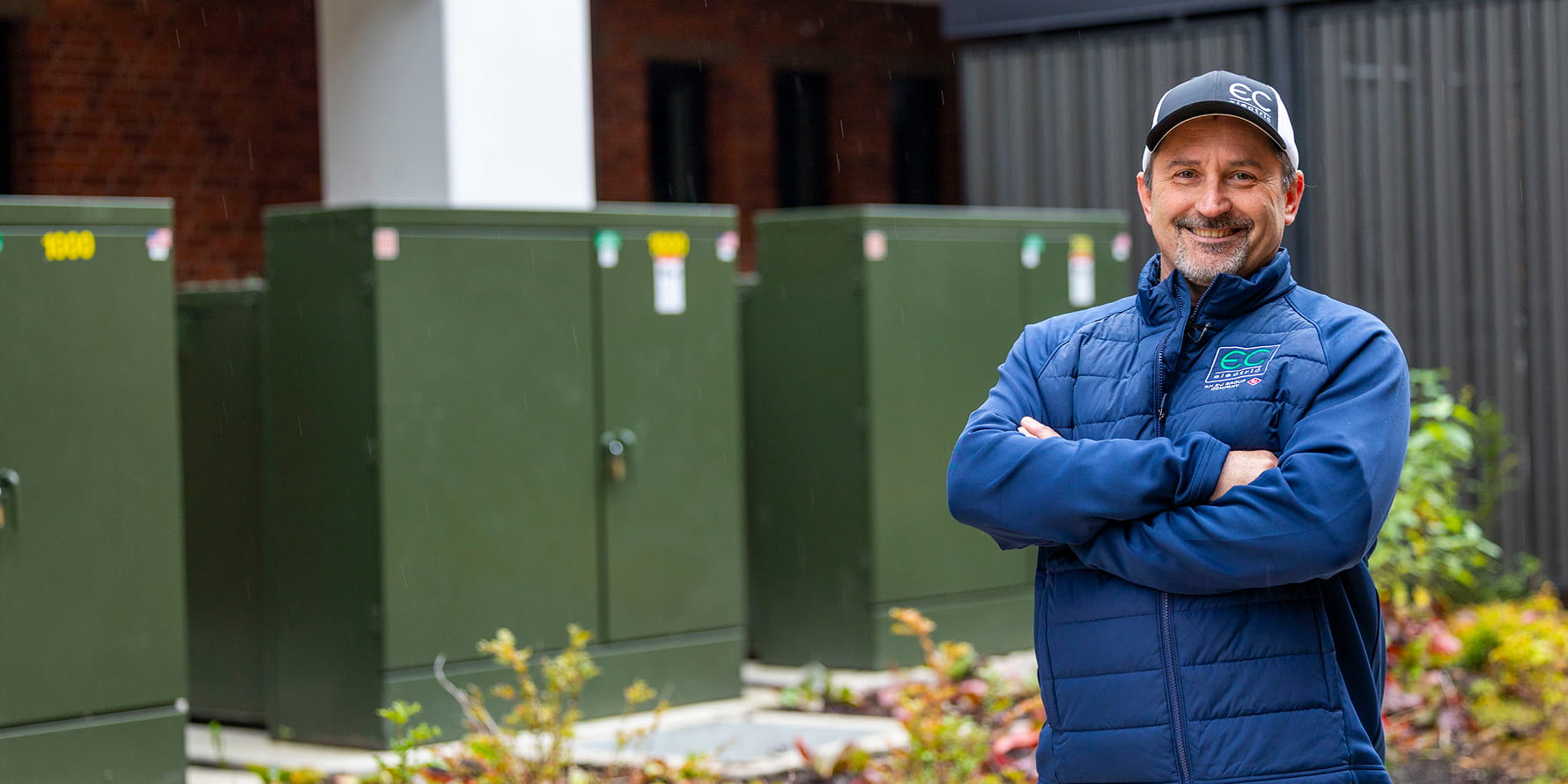 EC Electric contractor standing in front of three padmount transformers 