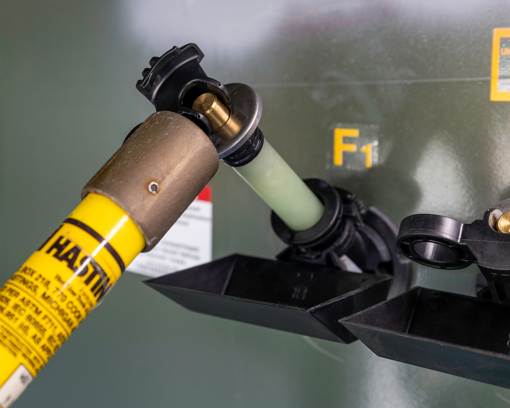 close up of removing bayonet fuse from padmount transformer using hot stick