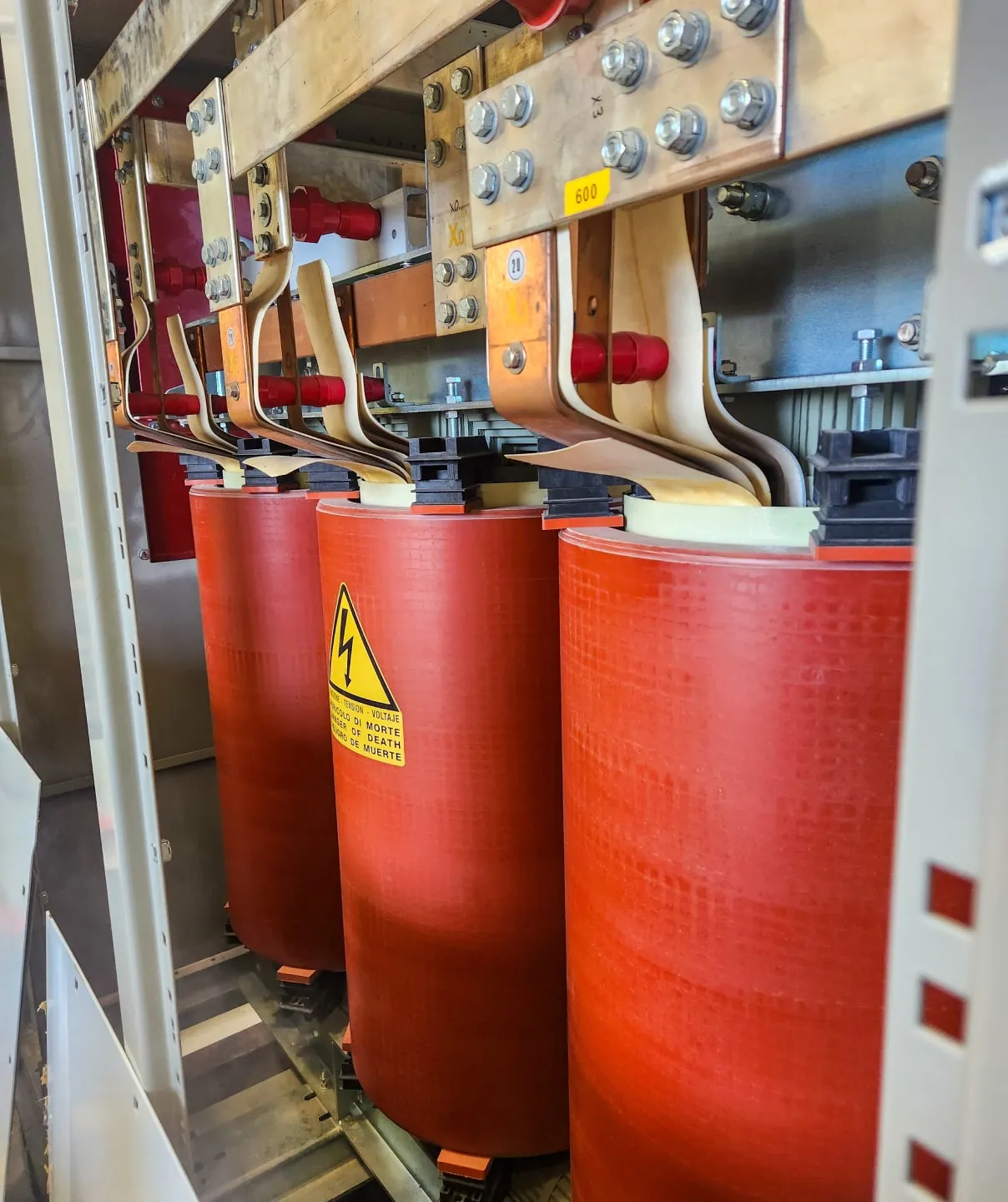 Close up photo of a cast coil transformer core and coils inside and enclosure