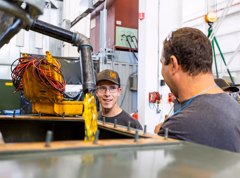 Maddox Transformer technicians filling a padmount transformer with insulating fluid
