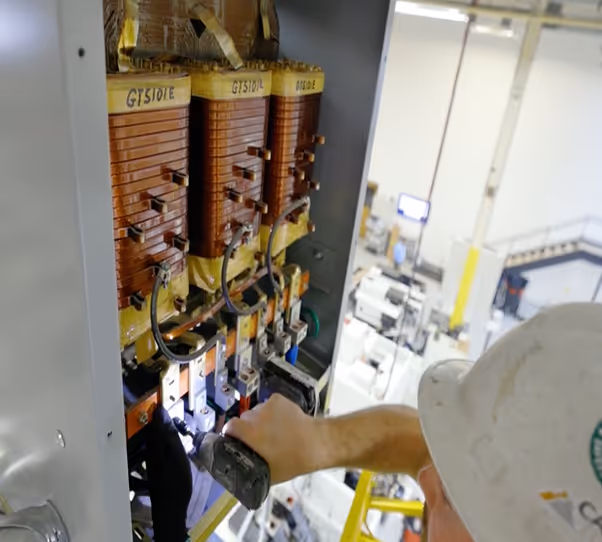 Worker installing a Maddox low voltage dry-type transformer