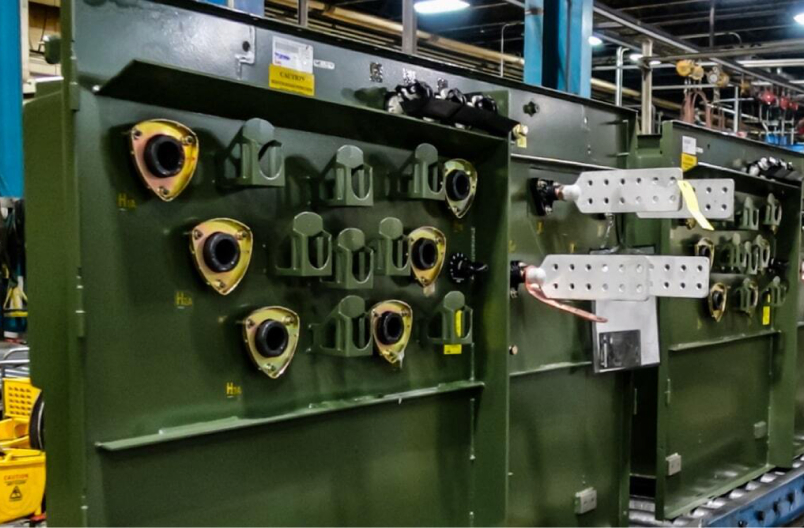 Close-up of padmount transformer bushings and connections