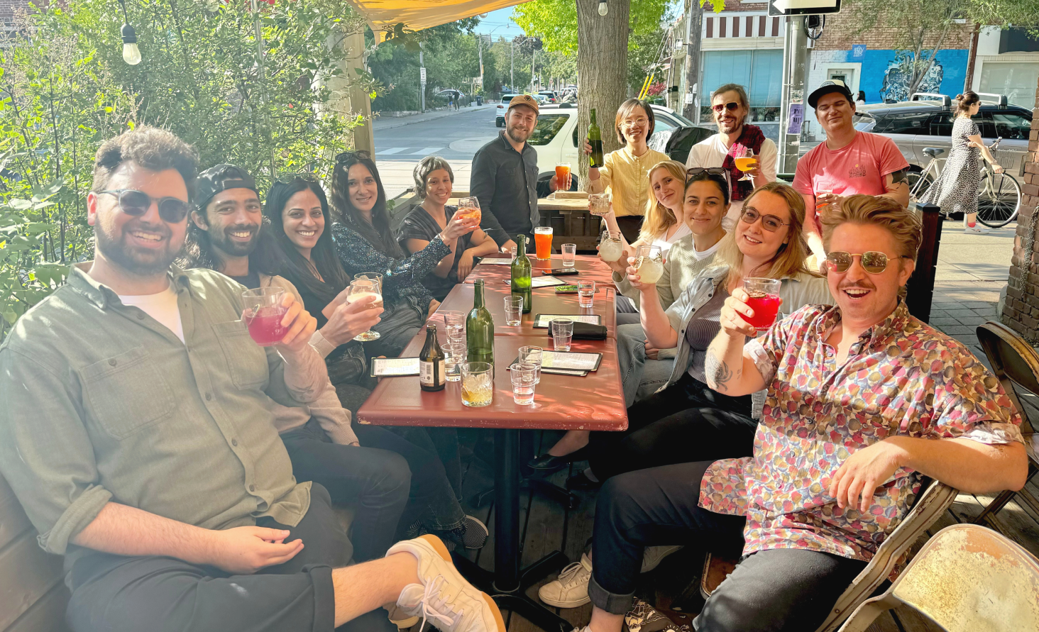 A group of people on a patio raising a glass