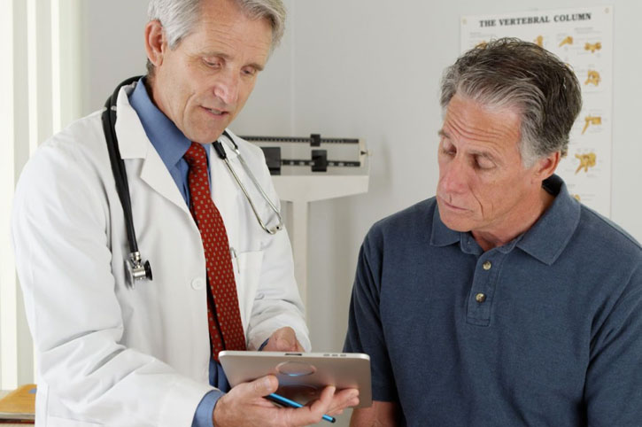 Doctor for veins explaining treatment plan to patient during clinic visit