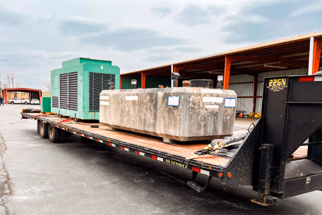 Hook 4 Hire hauling a large slab of concrete and a generator.