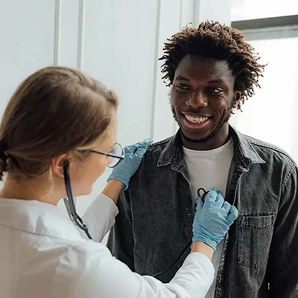 Doctor checks heart rate of patient in Los Angeles clinic promoting affordable primary healthcare