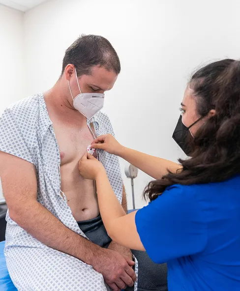 Doctor fitting patient with sensors for an electrocardiogram