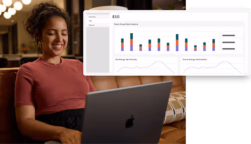 Woman sitting on a couch using a laptop with an ESG dashboard showing greenhouse gas emissions and energy use charts superimposed.