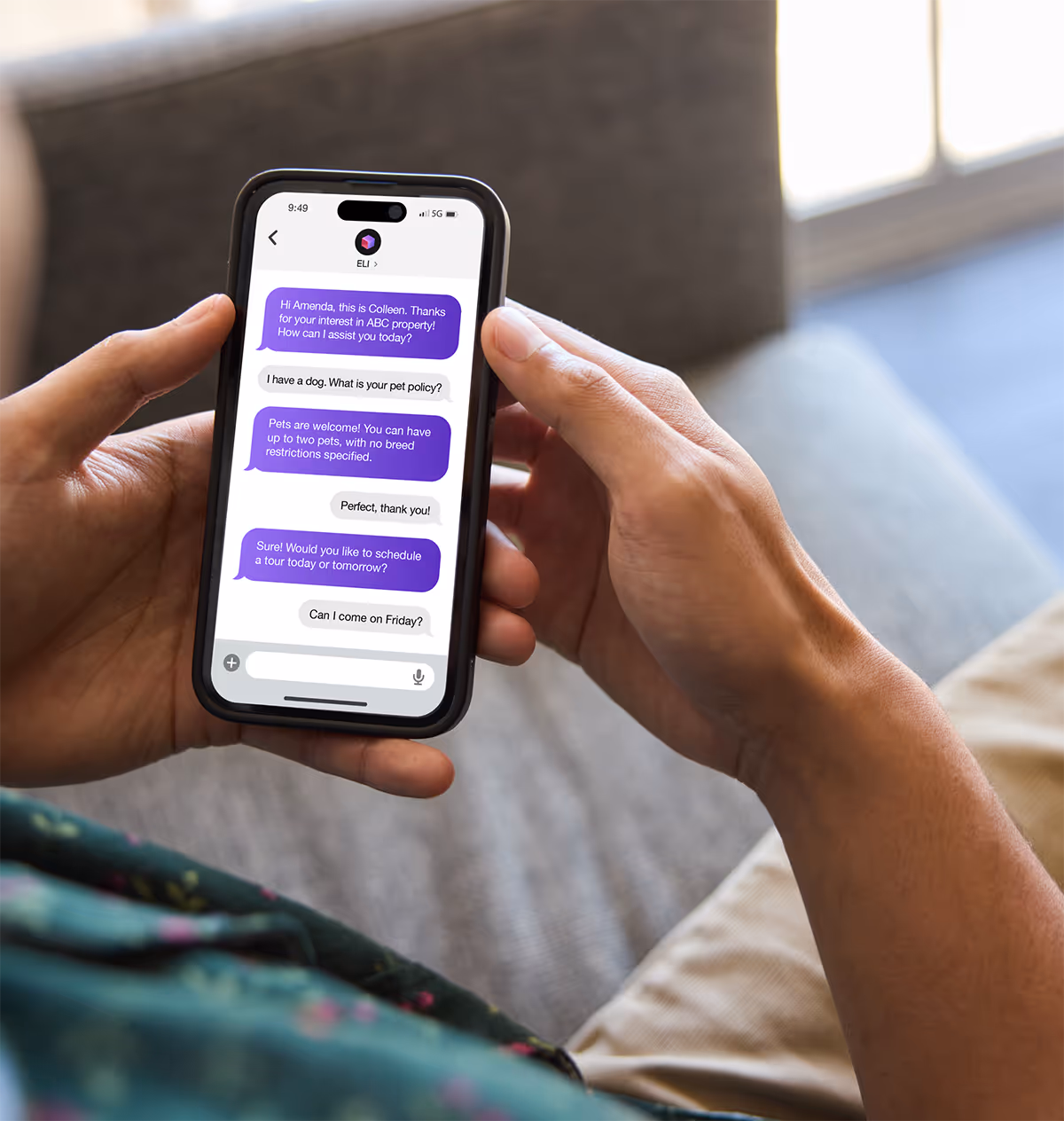 Person holding smartphone displaying text messages about pet policy and scheduling a property tour.