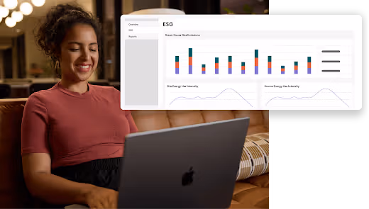 Woman sitting on a couch using a laptop with an ESG dashboard showing greenhouse gas emissions and energy use charts superimposed.